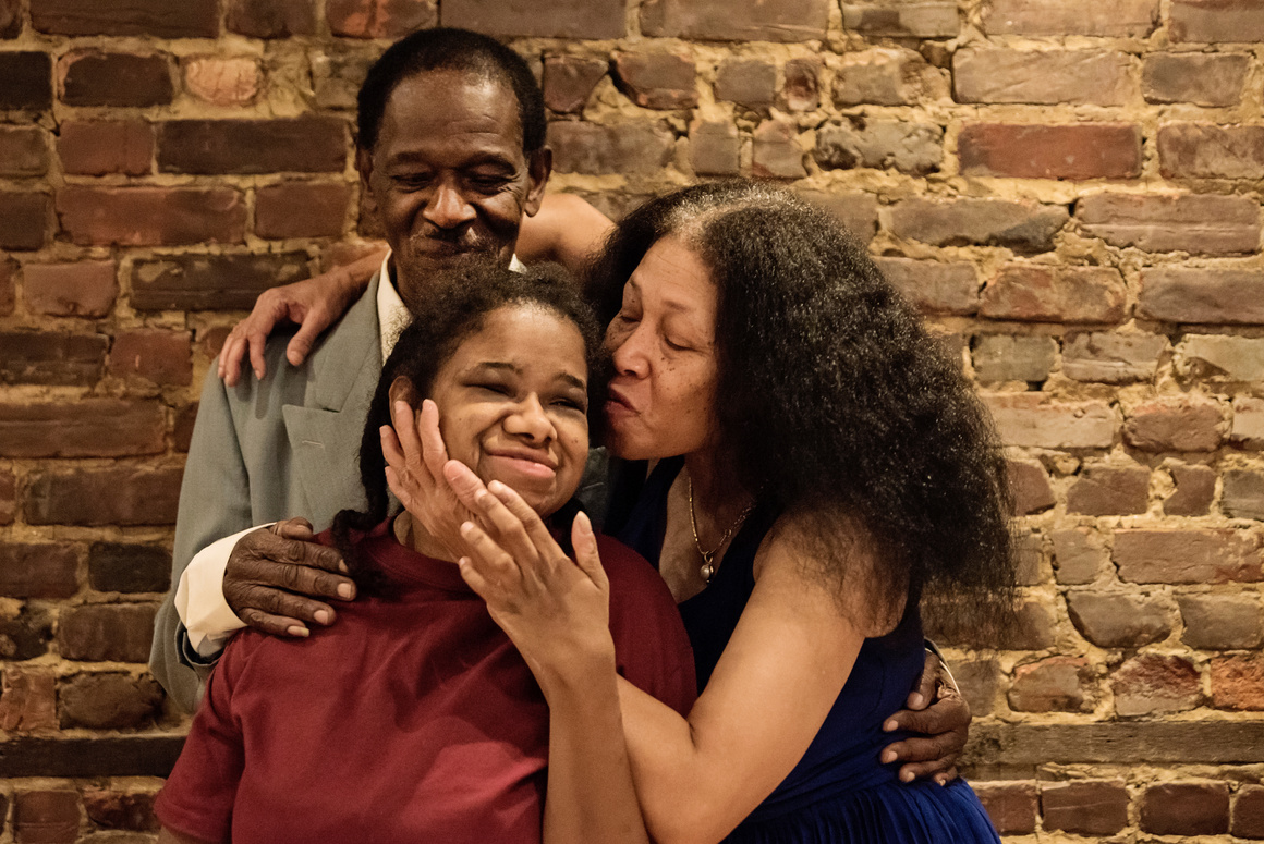 Portrait of senior parents with disable adult daughter.