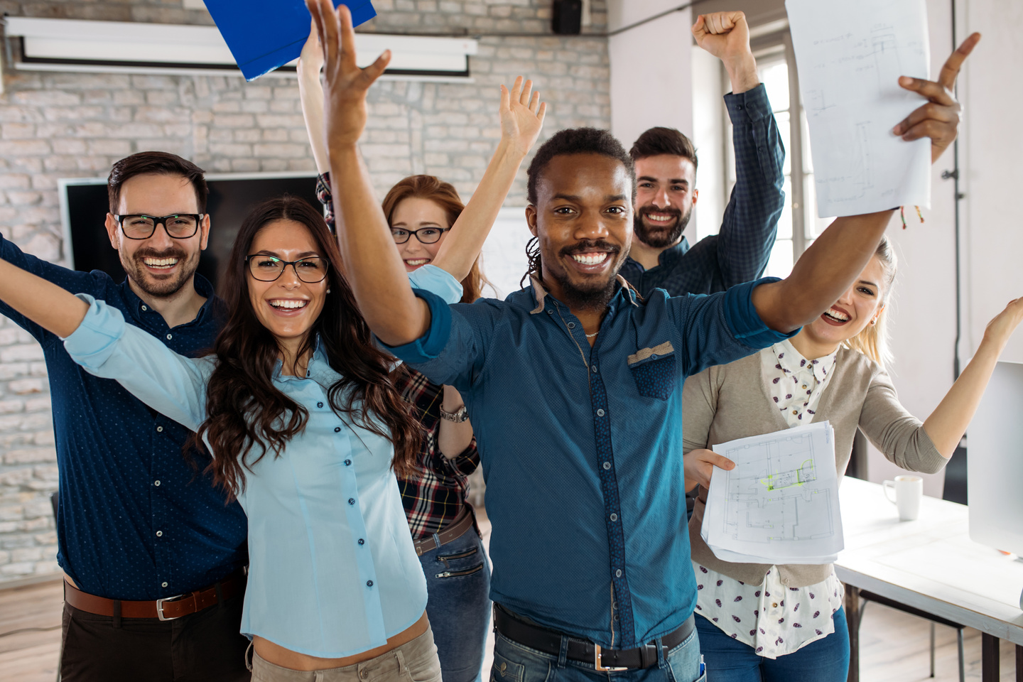 Happy group of successful company employees in office